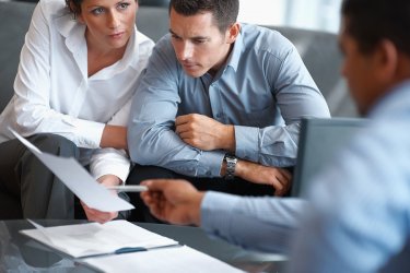 Real estate agent consulting a mature couple at office